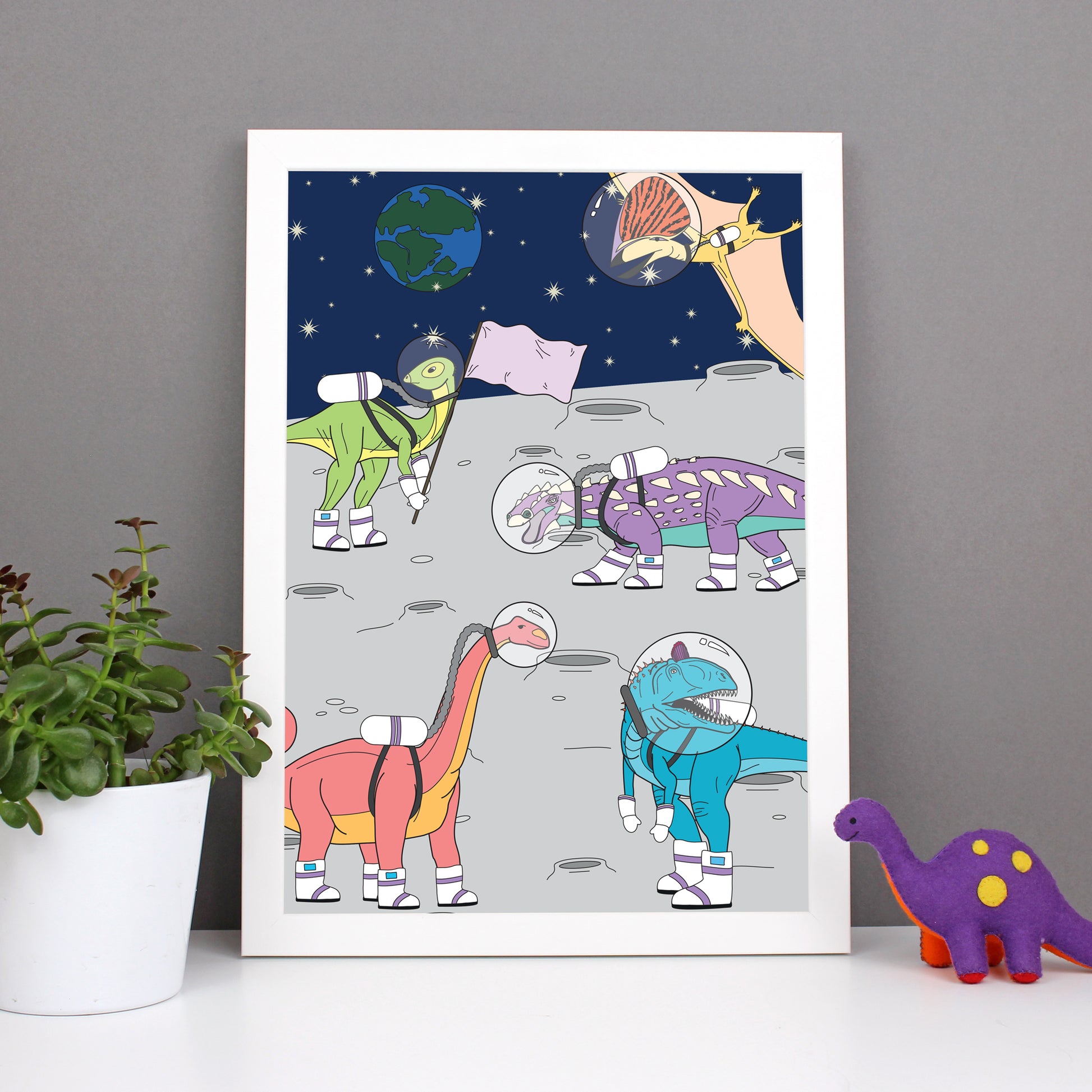 dinosaur space print in a white frame