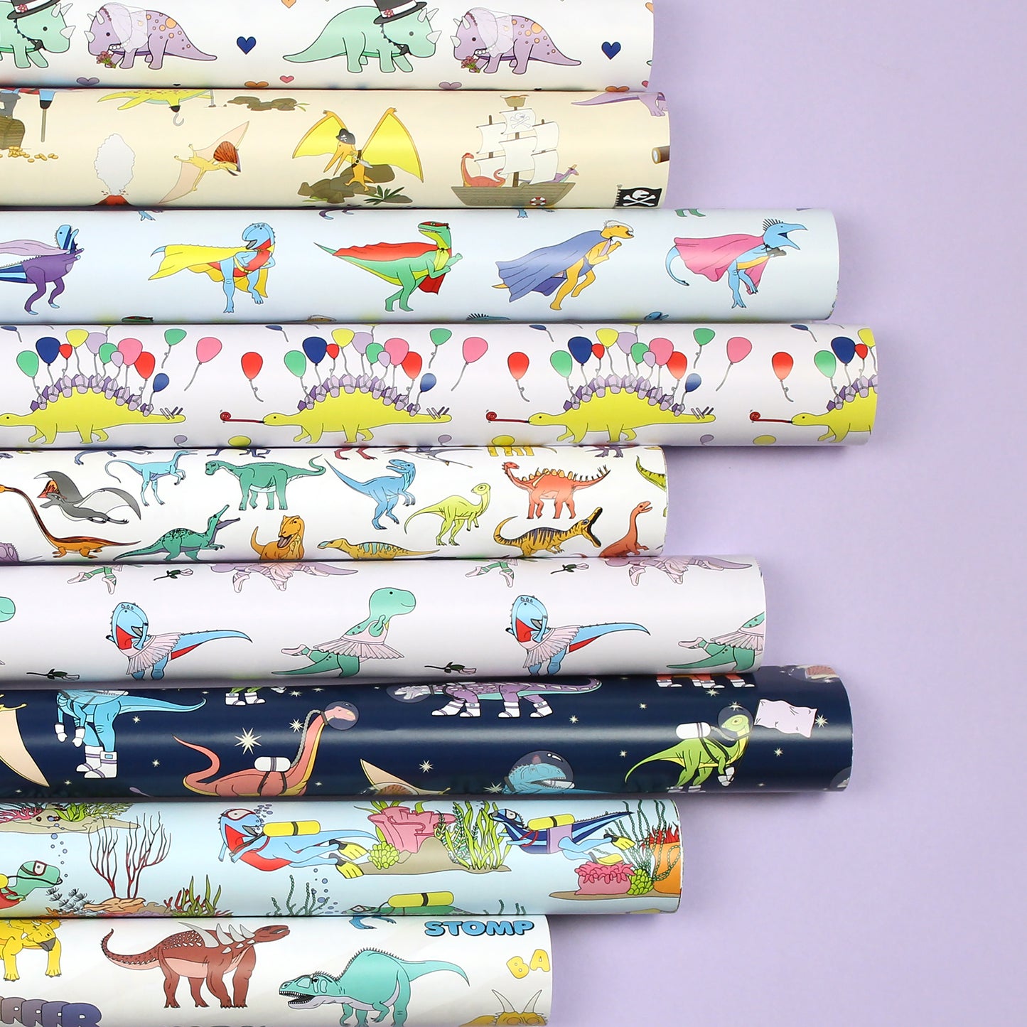 Rolled sheets of wrapping paper on a purple background