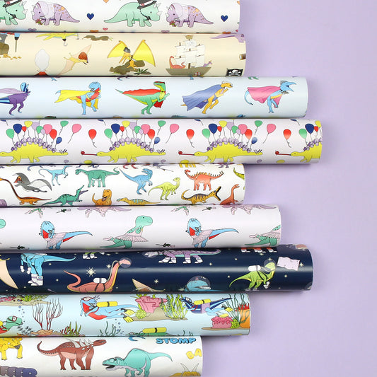 Rolled sheets of wrapping paper on a purple background