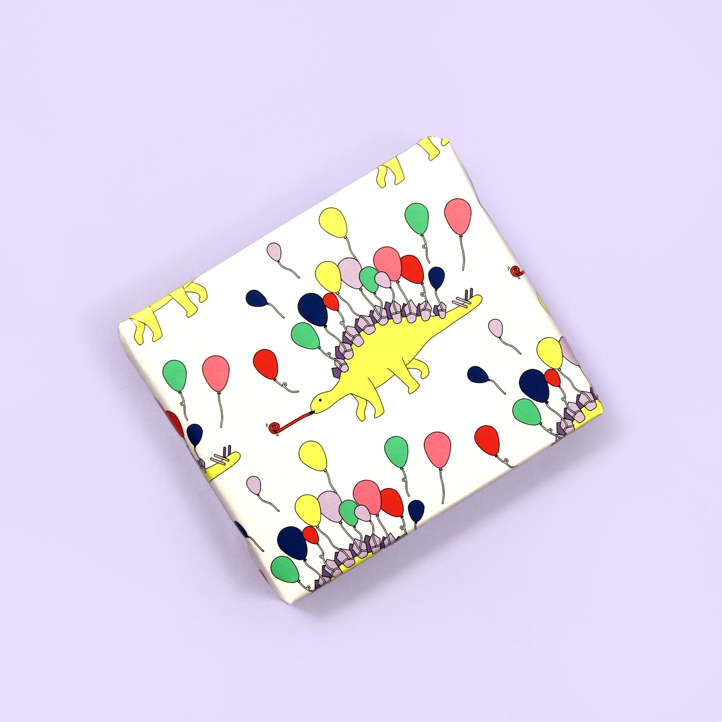 a small box wrapped in party animal Dinosaur Wrapping Paper