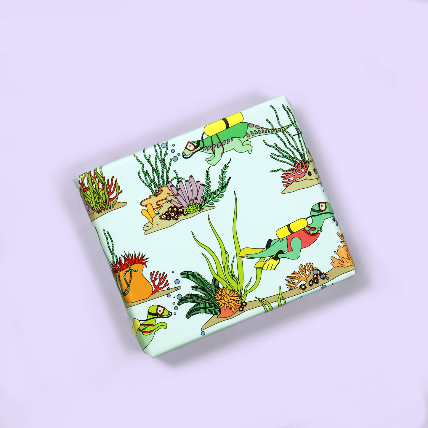 a small box wrapped in Under the Sea Dinosaur Wrapping Paper