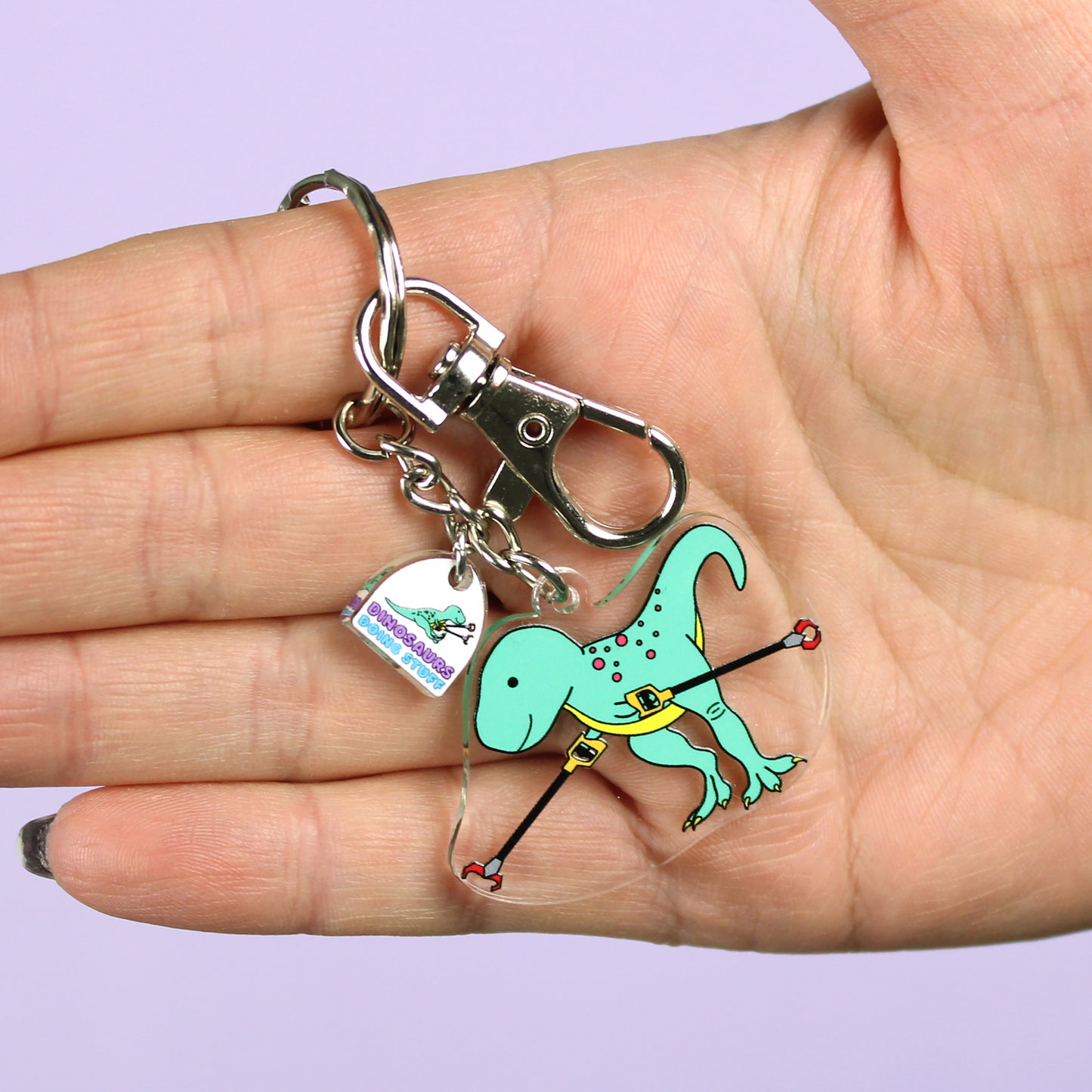 grabby arms dinosaur keyring on a hand