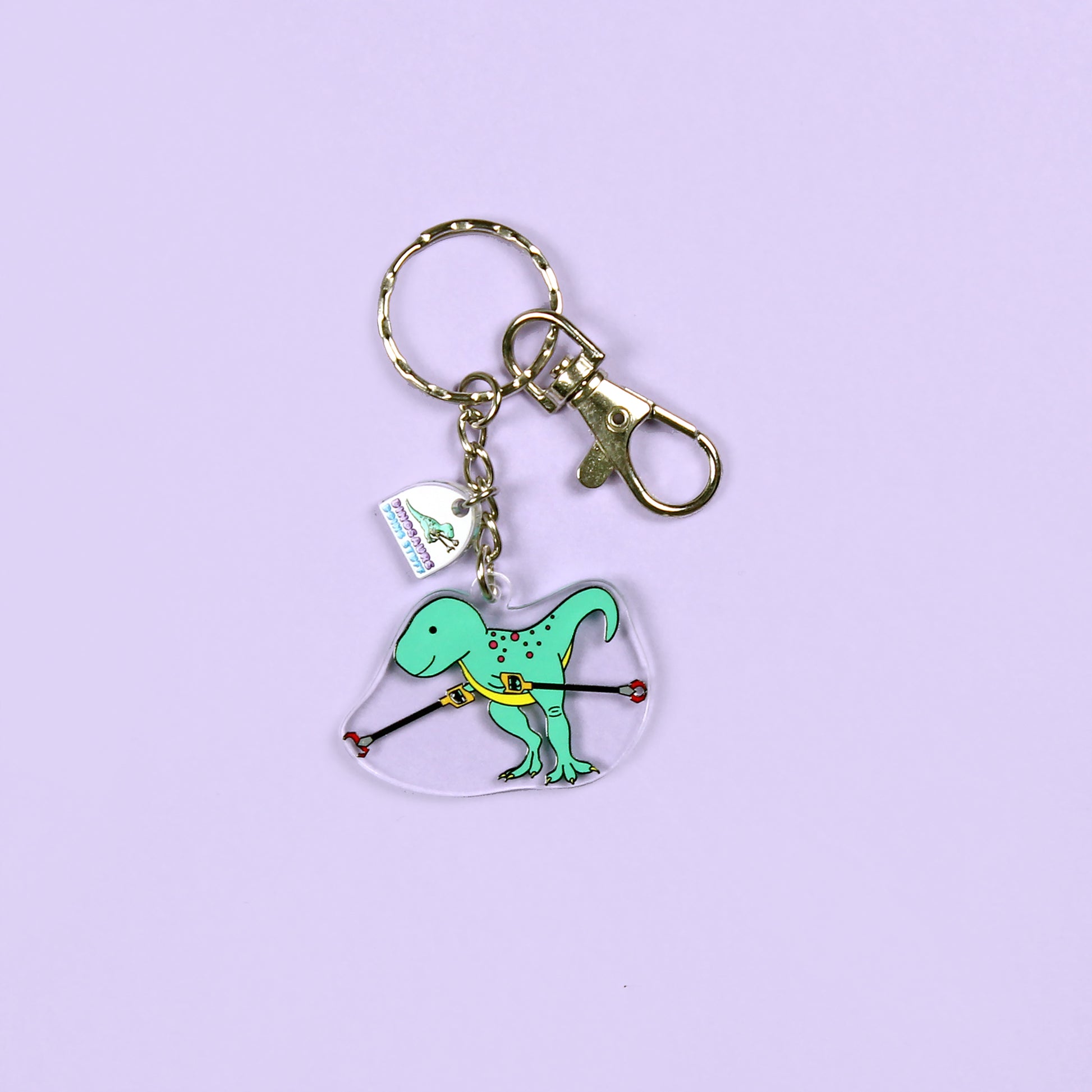 grabby arms dinosaur keyring on a purple background