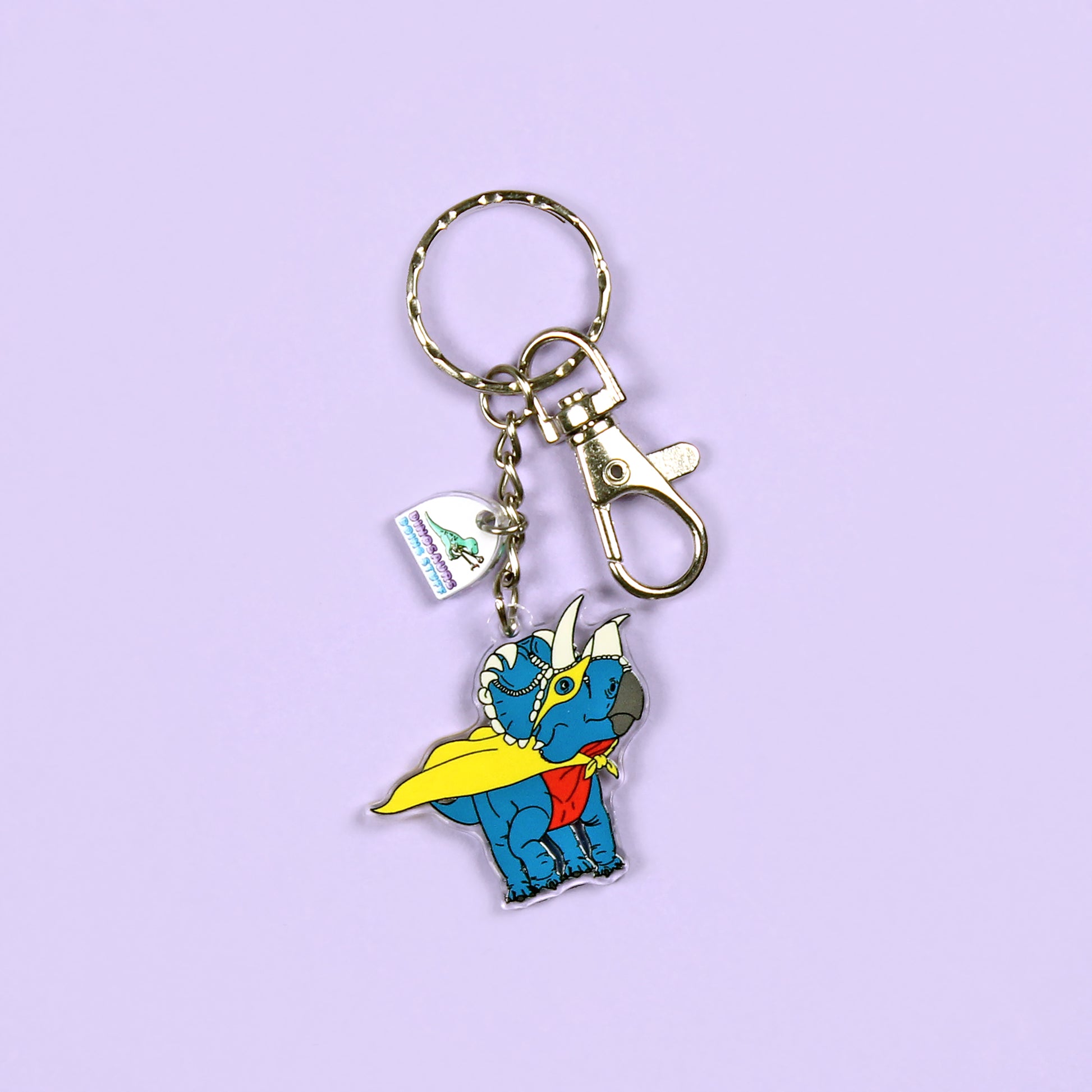 Superhero Dinosaur Keyring on a purple background