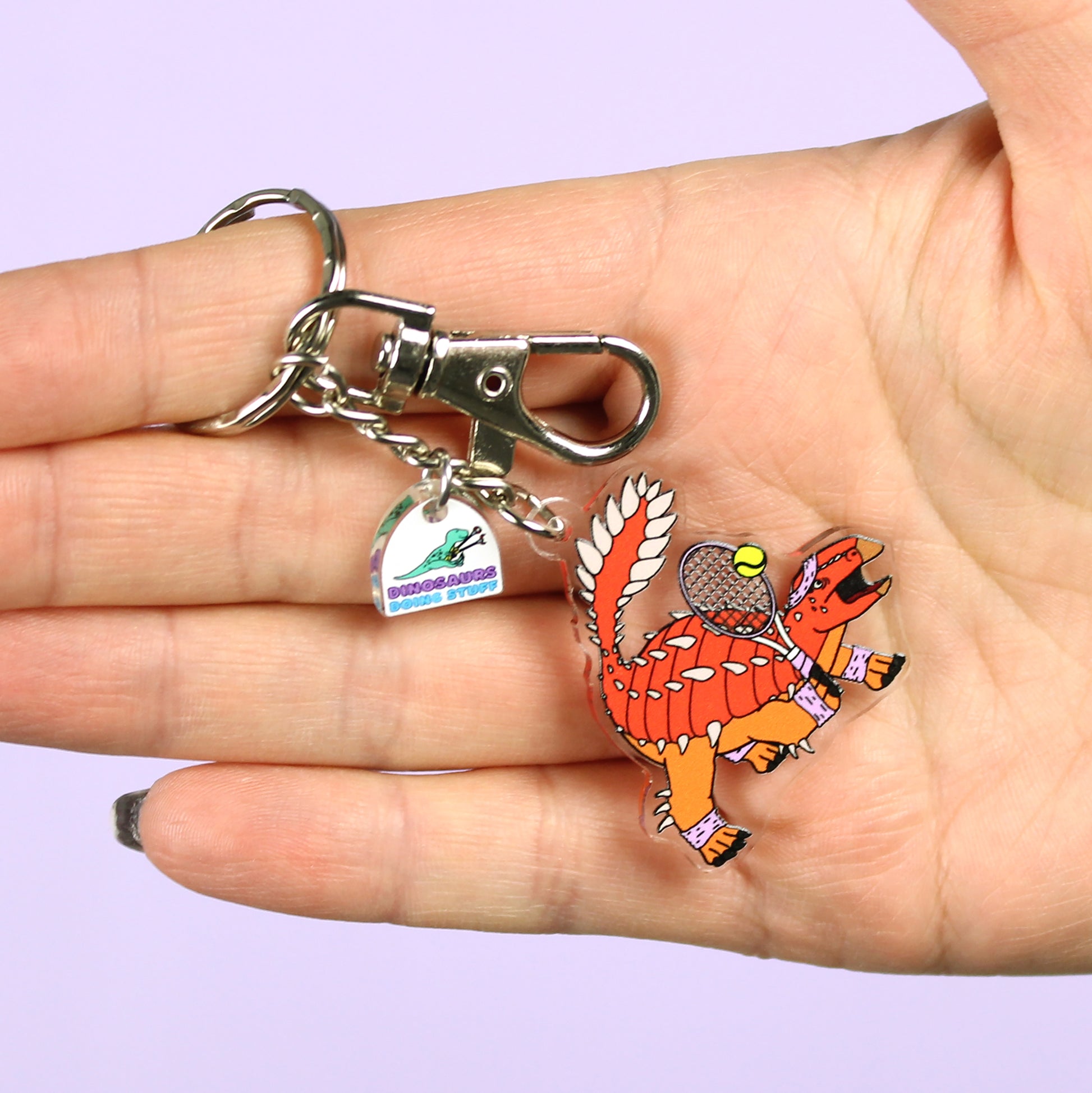 Tennis Dinosaur Keyring on a hand