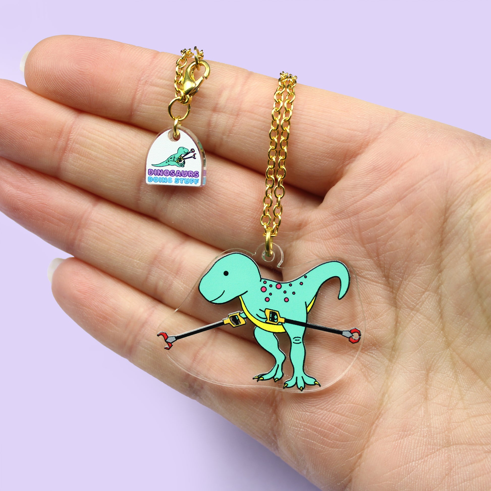 Grabby Arms Dinosaur Necklace on a hand