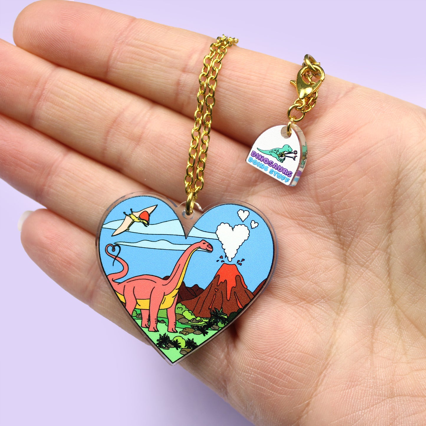 Heart Dinosaur Necklace on a hand