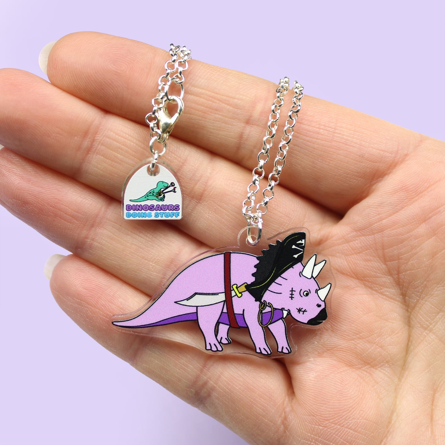 Pirate Dinosaur Necklace on a hand