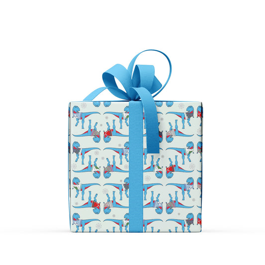 box covered in ugly jumper dinosaur wrapping paper with a blue bow