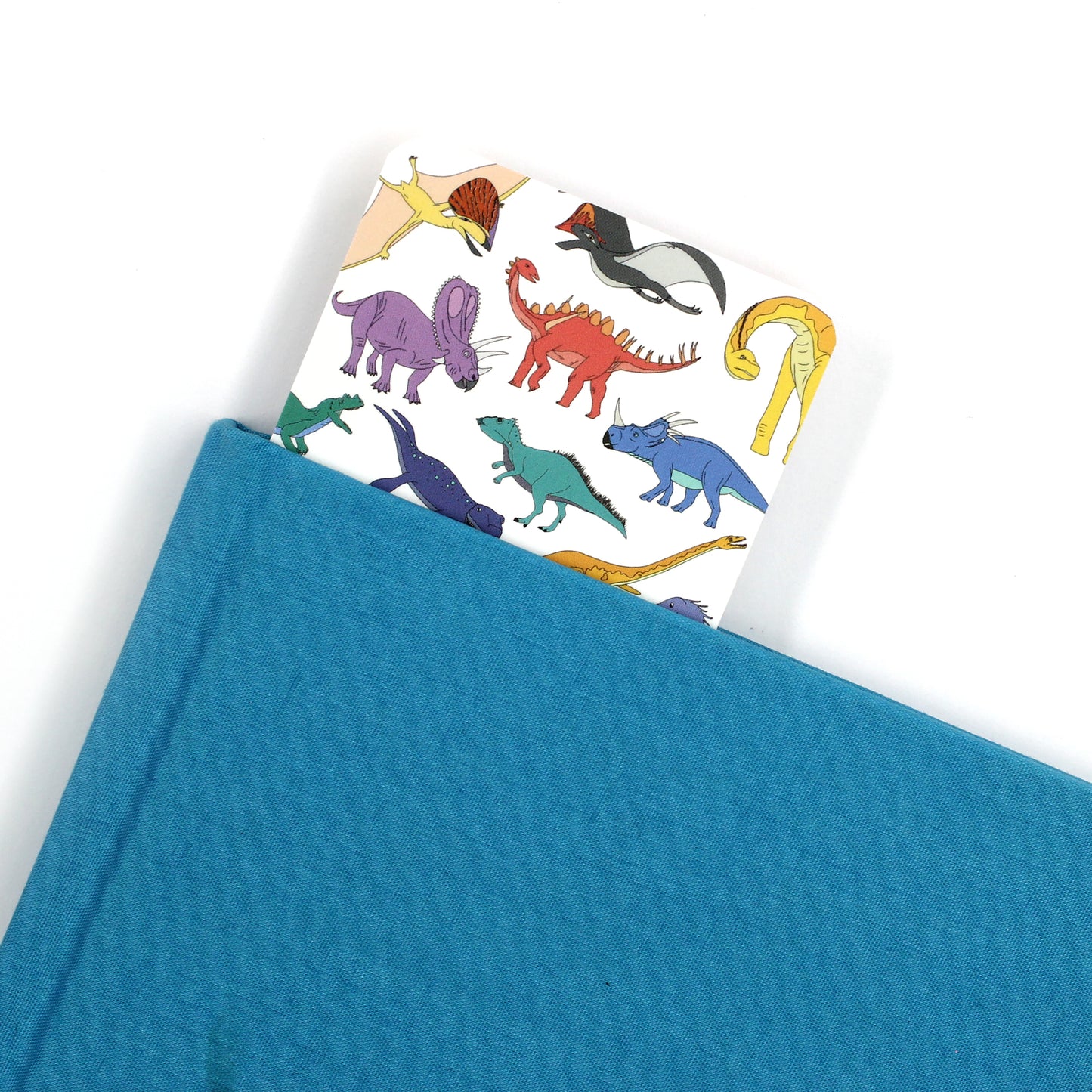 scatter dinosaur bookmark coming out a a blue book