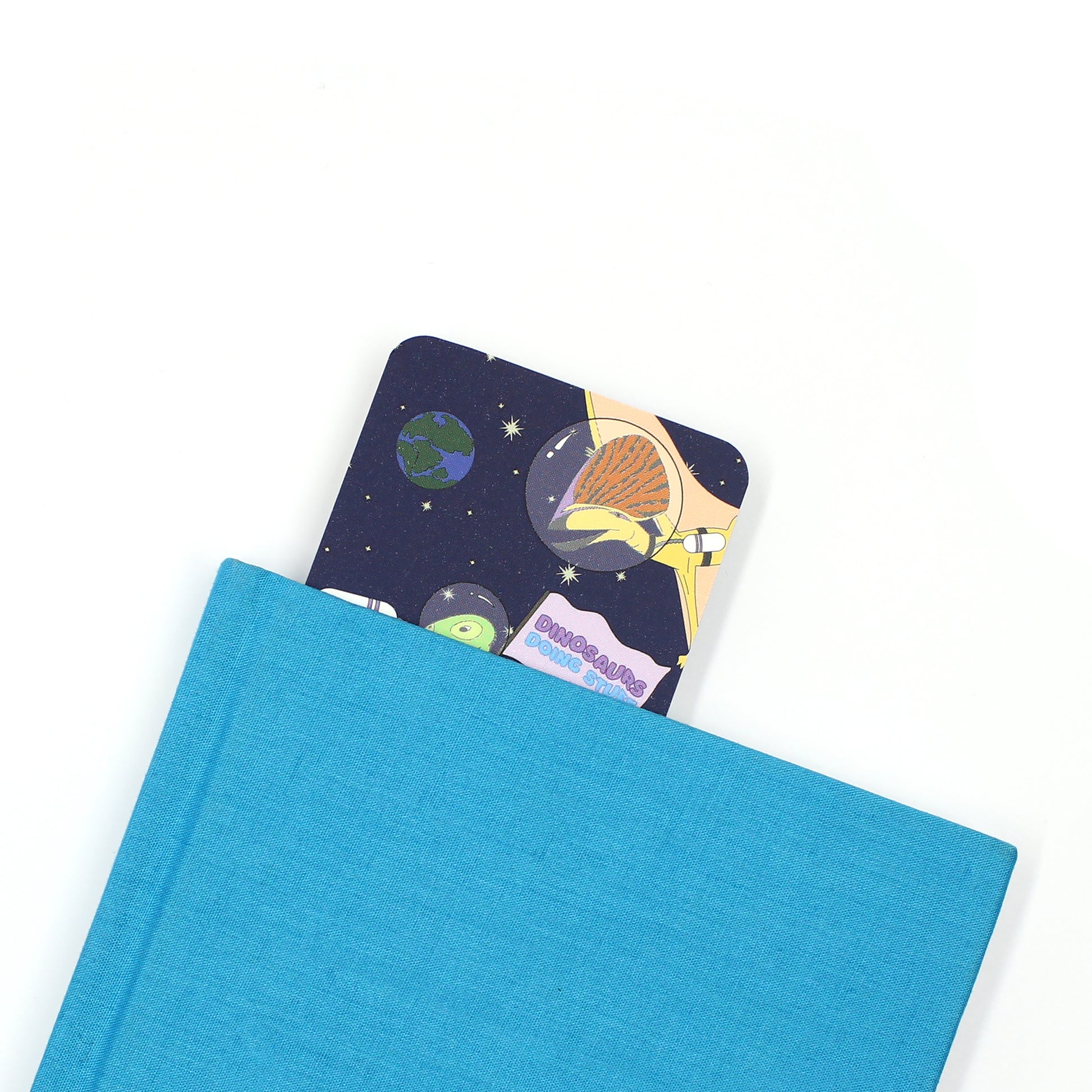 space dinosaur bookmark coming out of a blue book