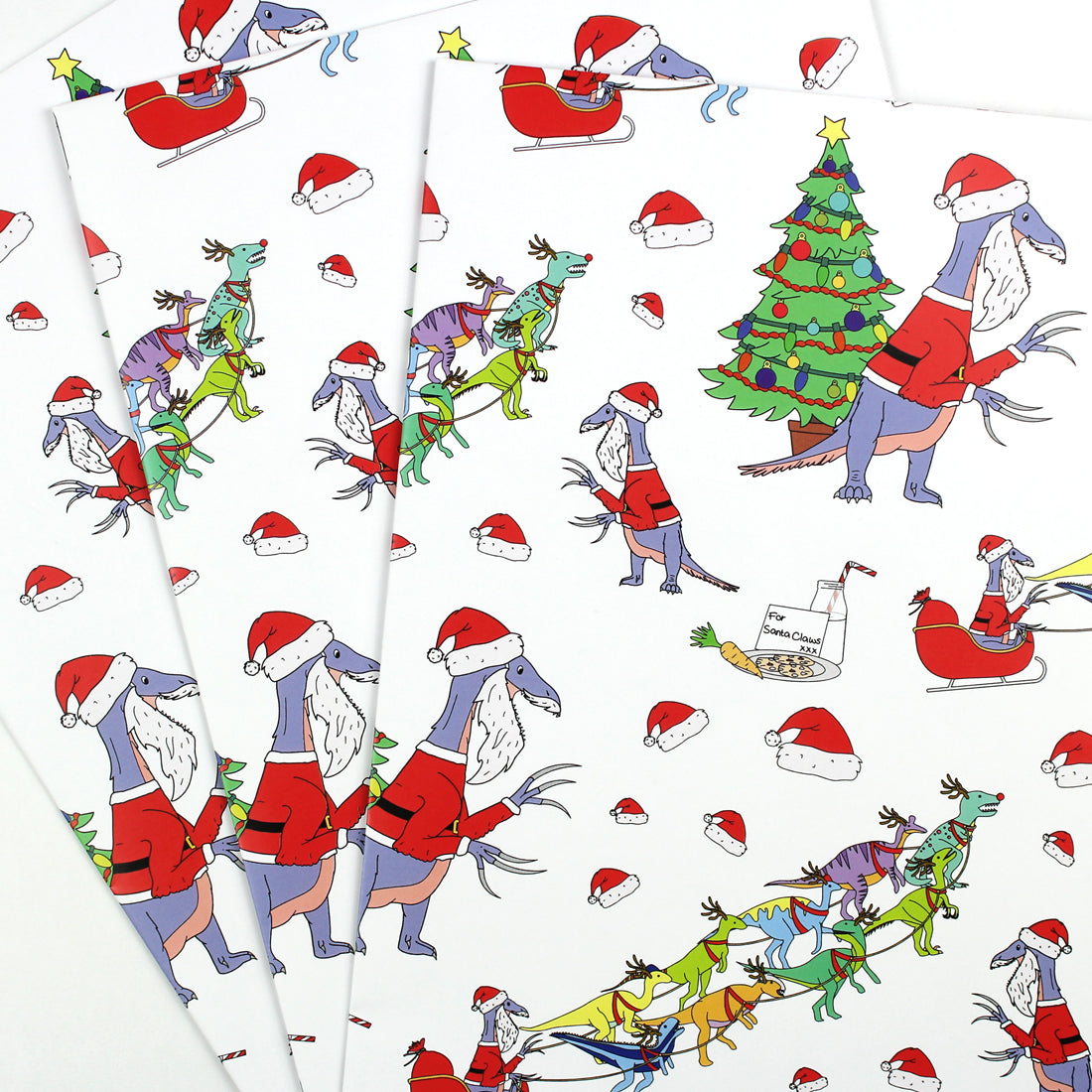 3 sheets of Santa Claws Dinosaur Christmas wrapping paper fanned out