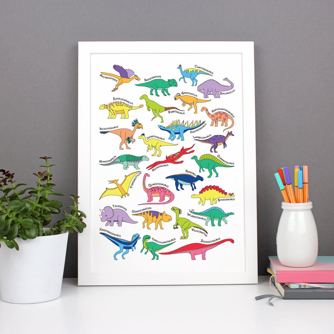Dinosaur Alphabet Poster Print in a white frame