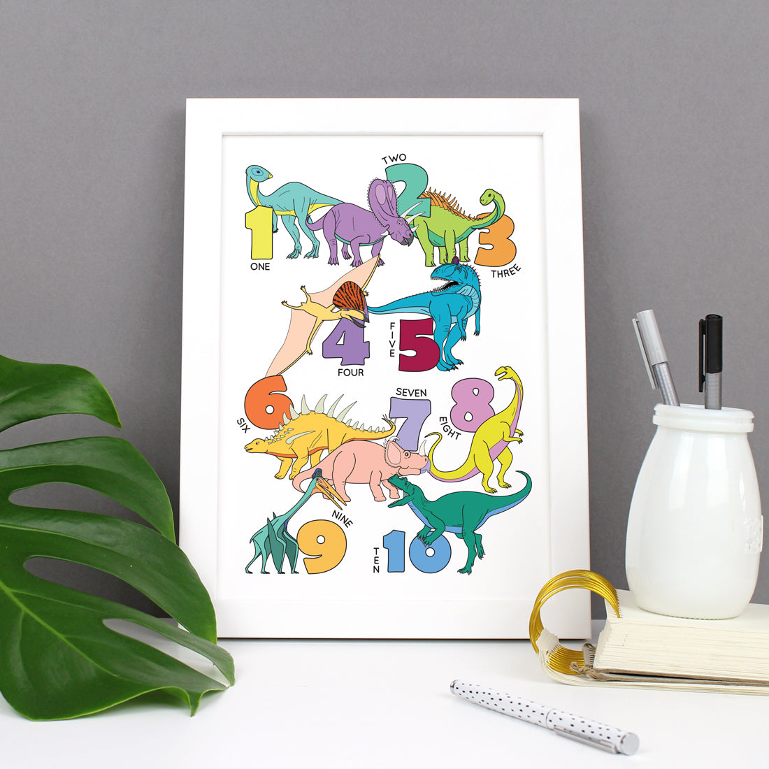 dinosaur number poster print in a white frame
