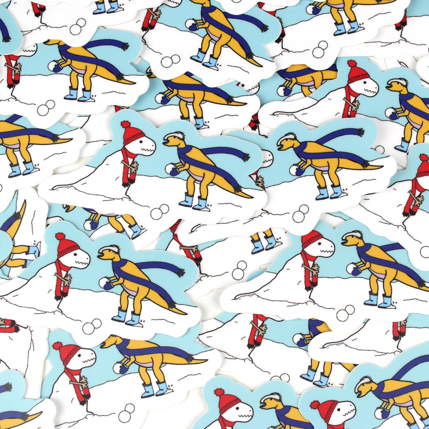 dinosaur making a snow-rex snow man stickers scattered in a pile