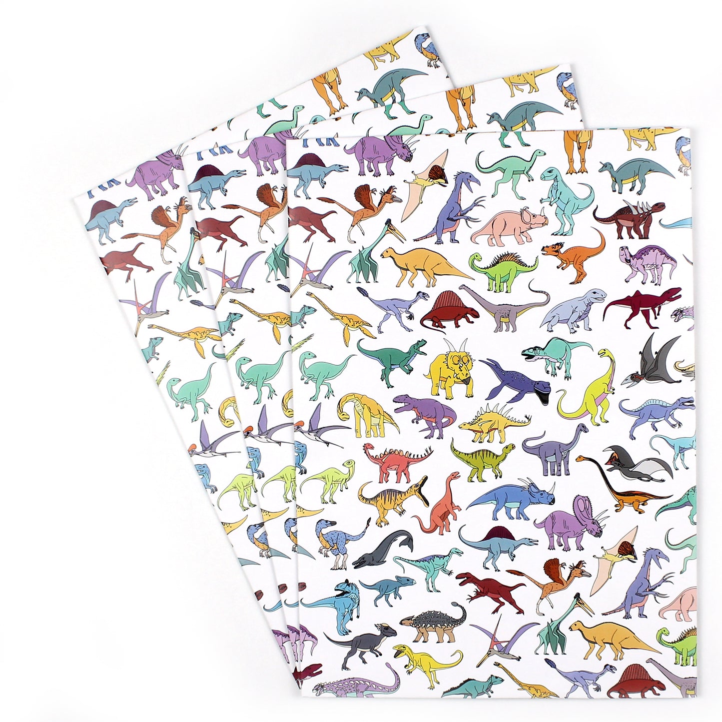 3 sheets of scattered dinosaur wrapping paper fanned out