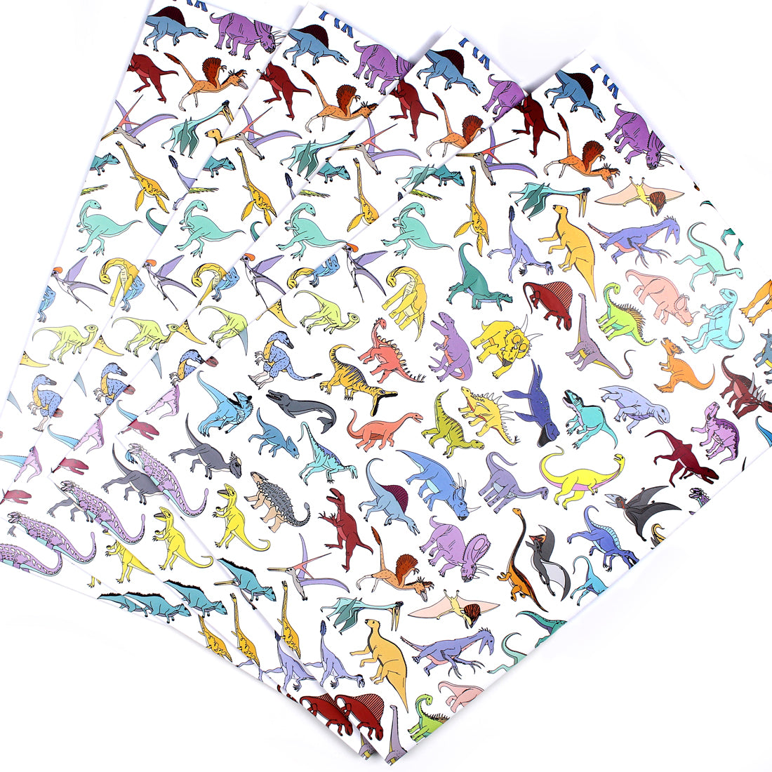 3 sheets of scattered dinosaur wrapping paper fanned out