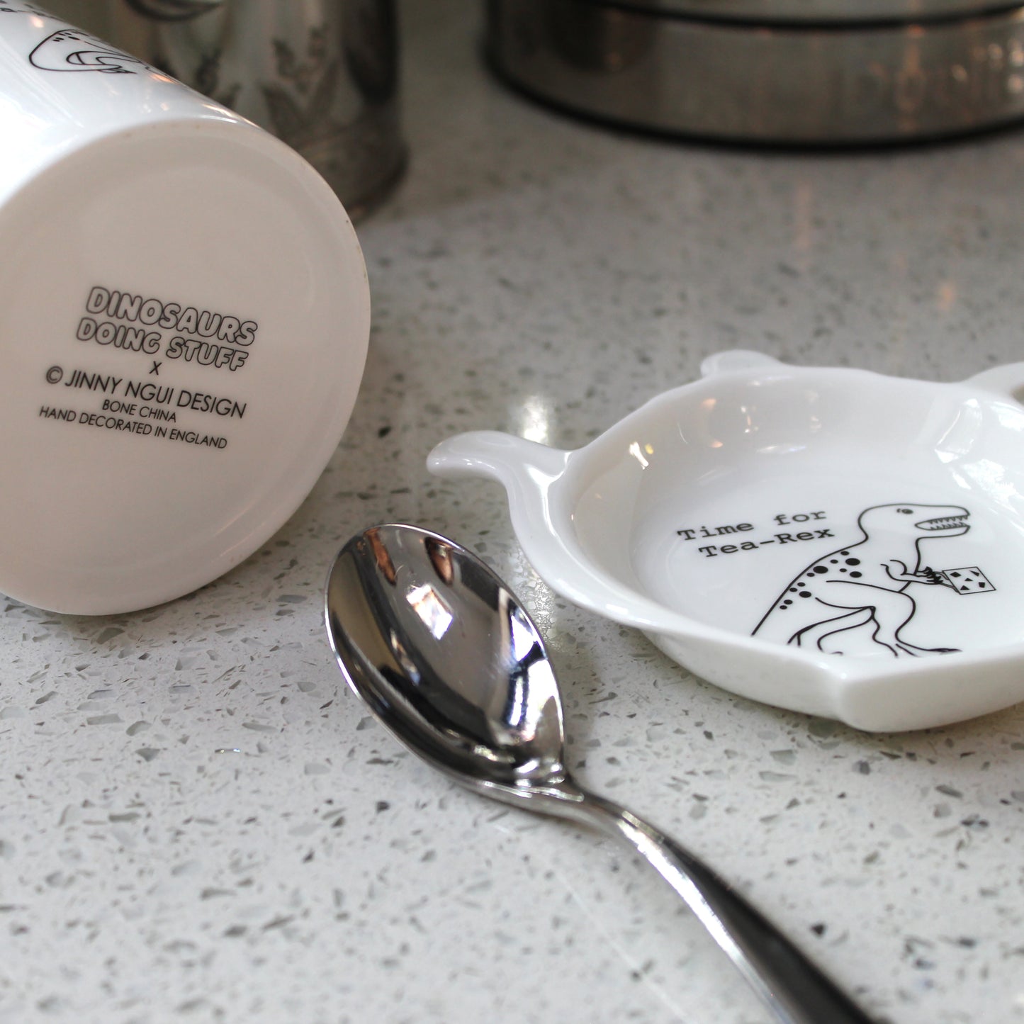 Time for Tea-Rex Mug and Teabag Tidy set on a kitchen bench with a spoon