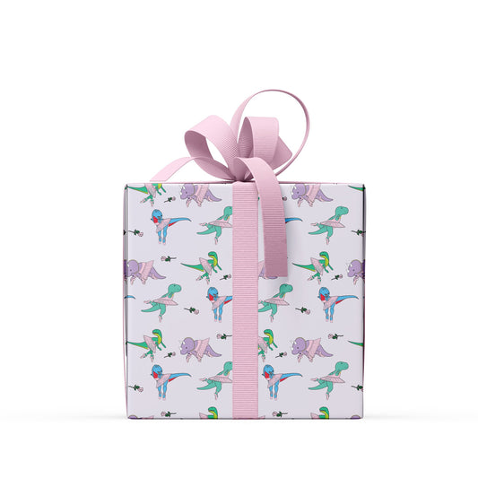 box wrapped in ballet dinosaur wrapping paper with a pink ribbon