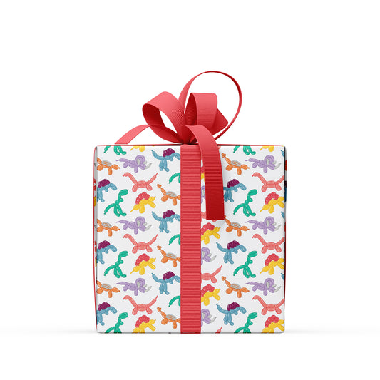 box covered in balloon animal dinosaur wrapping paper  with a red ribbon