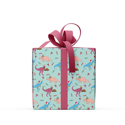 box wrapped in dinner dinosaur wrapping paper with a dark red ribbon