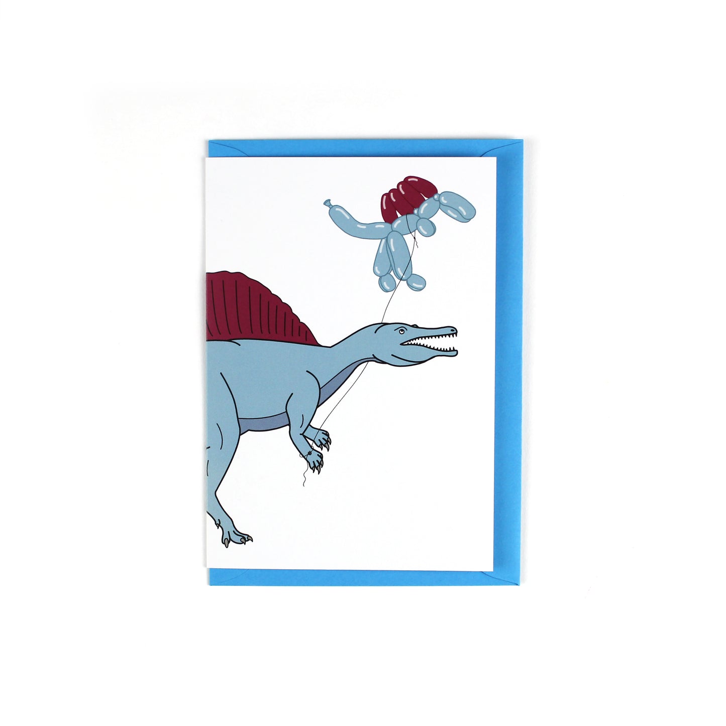 greeting card featuring a spinosaurus dinosaur holding a balloon dinosaur on a string