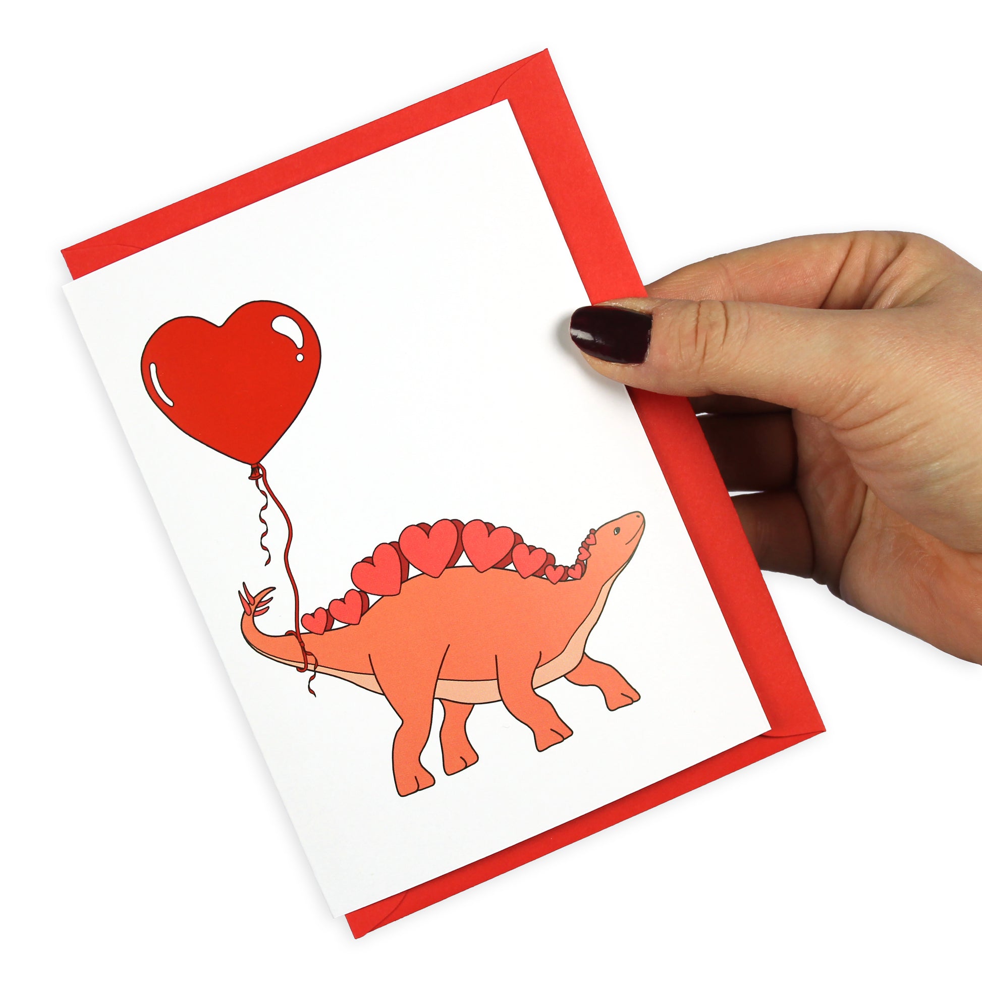 Heart Stegosaurus Dinosaur Greeting Card held by a hand