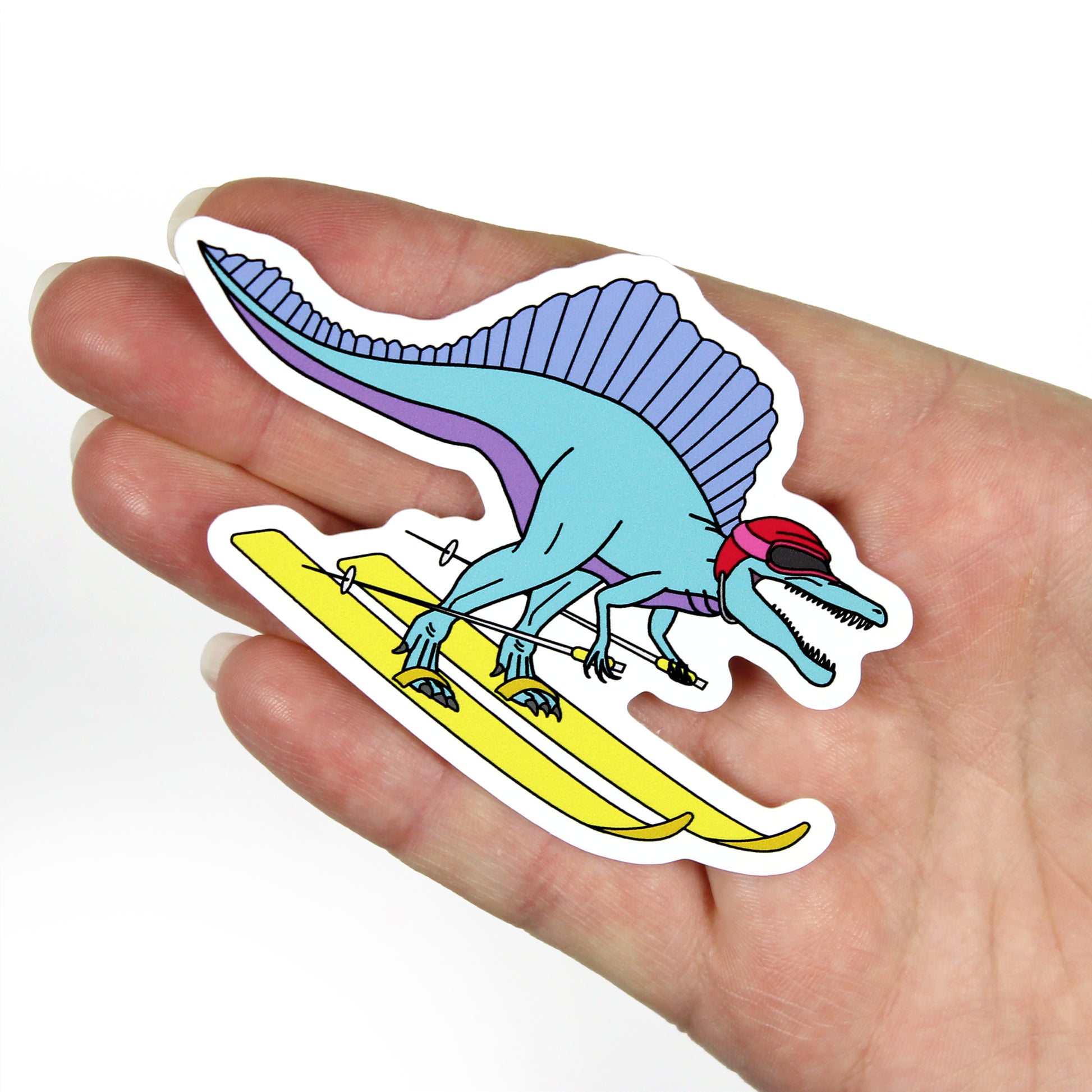 skiing dinosaur sticker on a hand with a white background