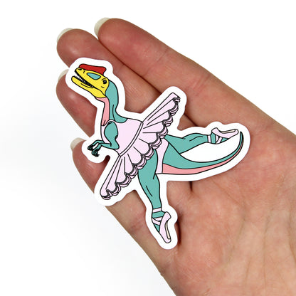 ballet dinosaur sticker on a hand with a white background