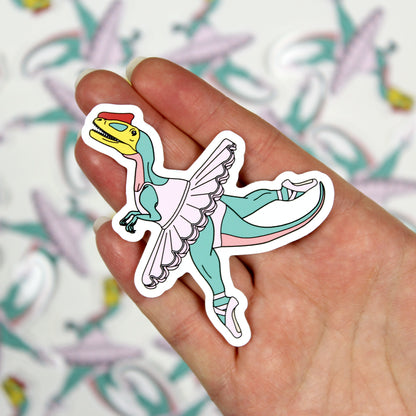 ballet dinosaur sticker on a hand with out of focus stickers in the background.