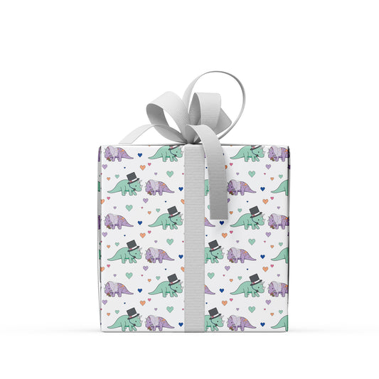 box covered in wedding dinosaur wrapping paper with a grey ribbon