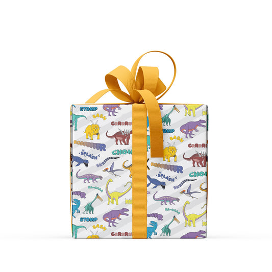 box wrapped in dinosaur words wrapping paper with a yellow ribbon