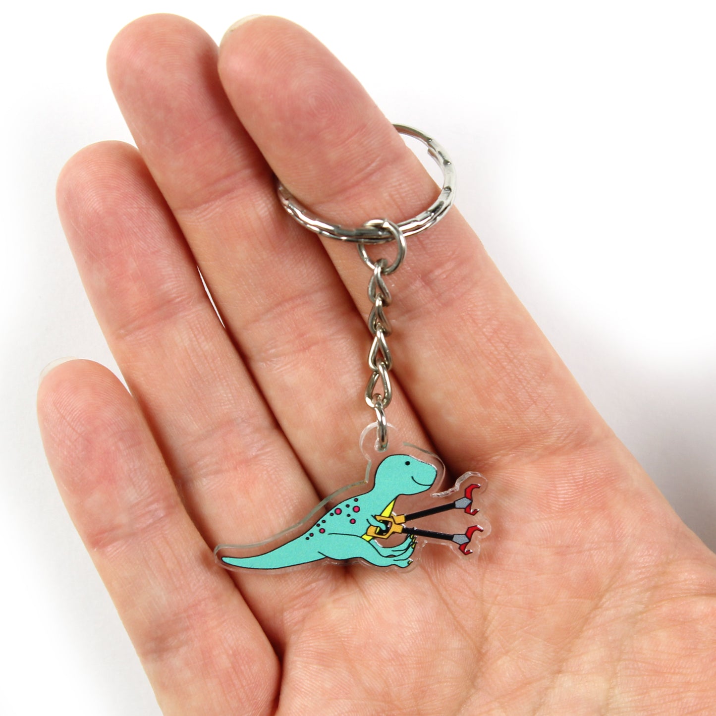 grabby arms t-rex dinosaur keyring on a hand with the split ring over a finger