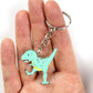 Zombie T-Rex dinosaur keyring on a hand with the split ring over a finger