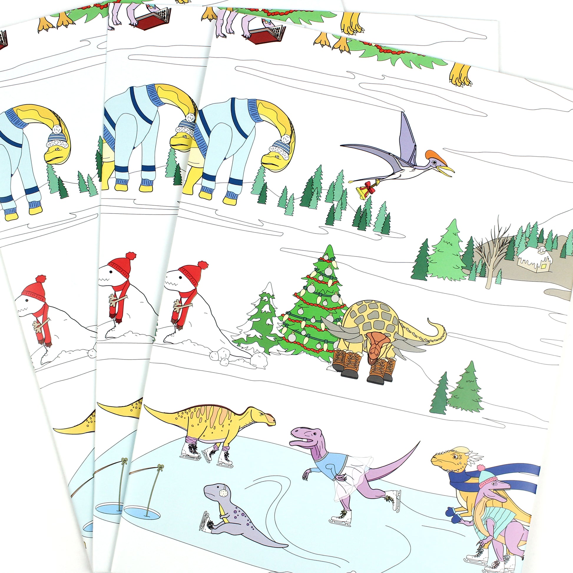 3 sheets of Dinosaur Christmas Winter Scene Wrapping Paper fanned out
