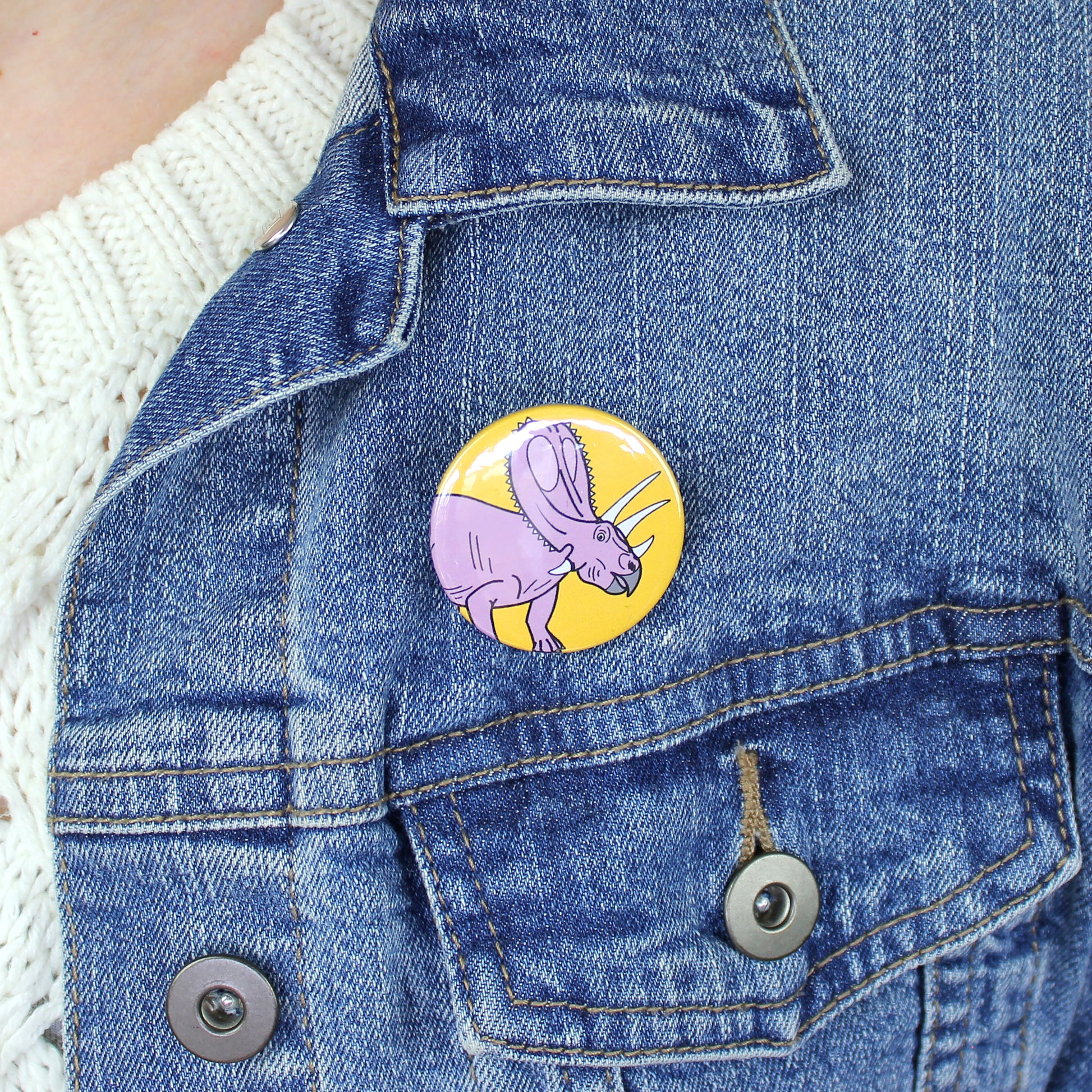 mini Titanoceratops badge on a denim jacket