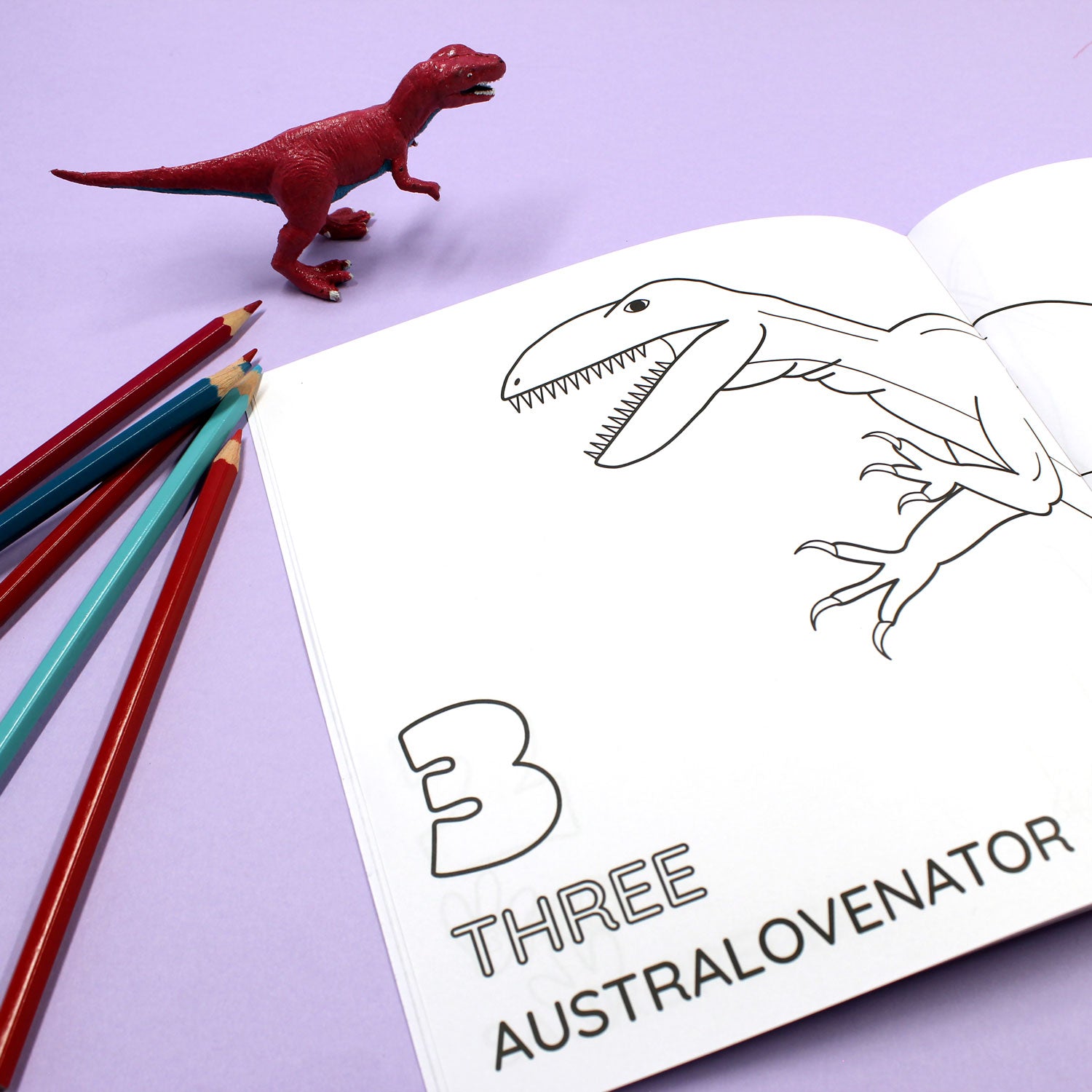 Inside page of 1234 Dinosaur colouring book. The page features black line illustration of an Australovenator with the number 3 and word 'three'
