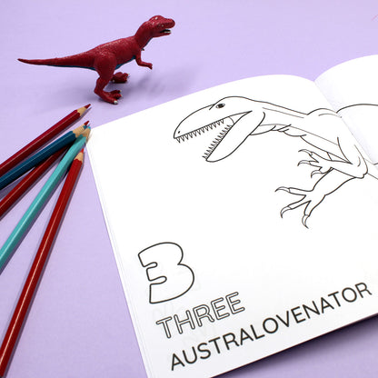Inside page of 1234 Dinosaur colouring book. The page features black line illustration of an Australovenator with the number 3 and word 'three'