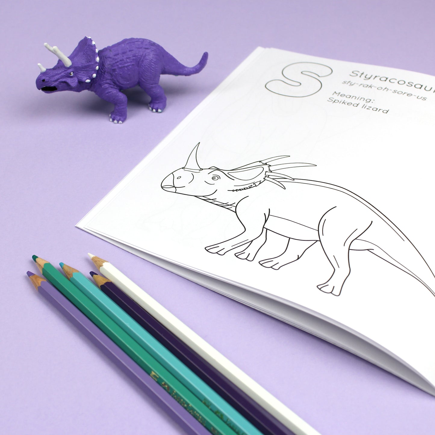Inside page of ABC Dinosaur colouring book. The page features black line illustration of a Styracosaurus dinosaur with its name, pronunciation and meaning above it.