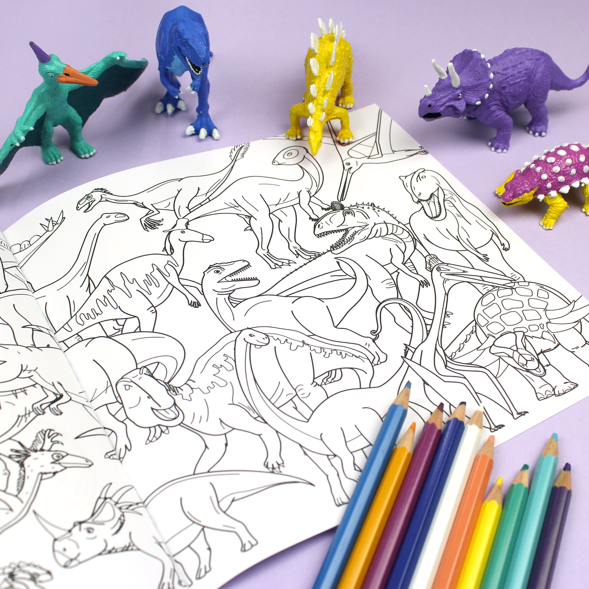 Inside page of ABC Dinosaur colouring book. The page features black line illustration of a collage of dinosaurs featured in the colouring book.