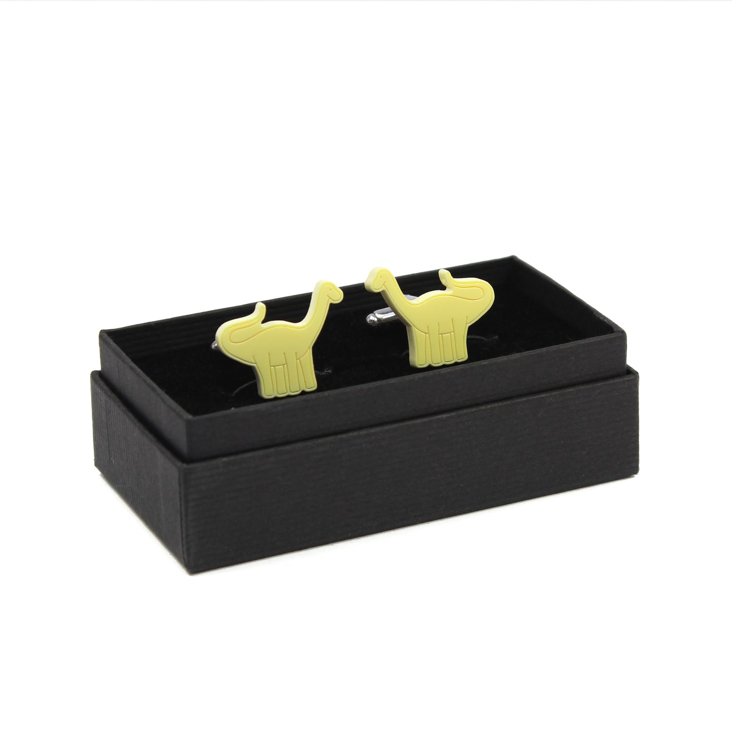 a pair of yellow brontosaurus cufflinks in a black box