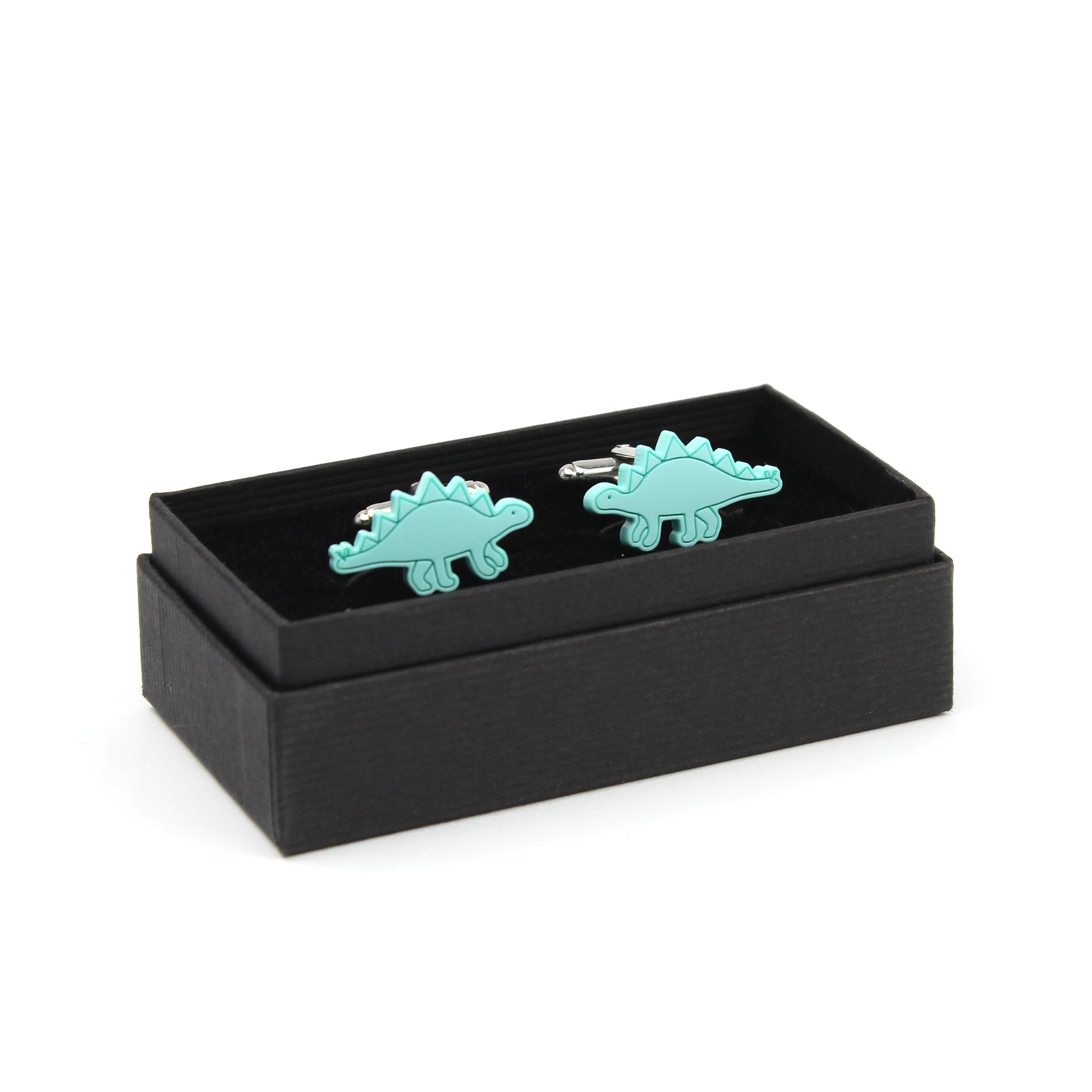 a pair of mint stegosaurus cufflinks in a black box