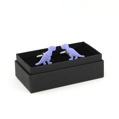 pair of blue tyrannosaurus-rex dinosaur cufflinks in a black cufflink box