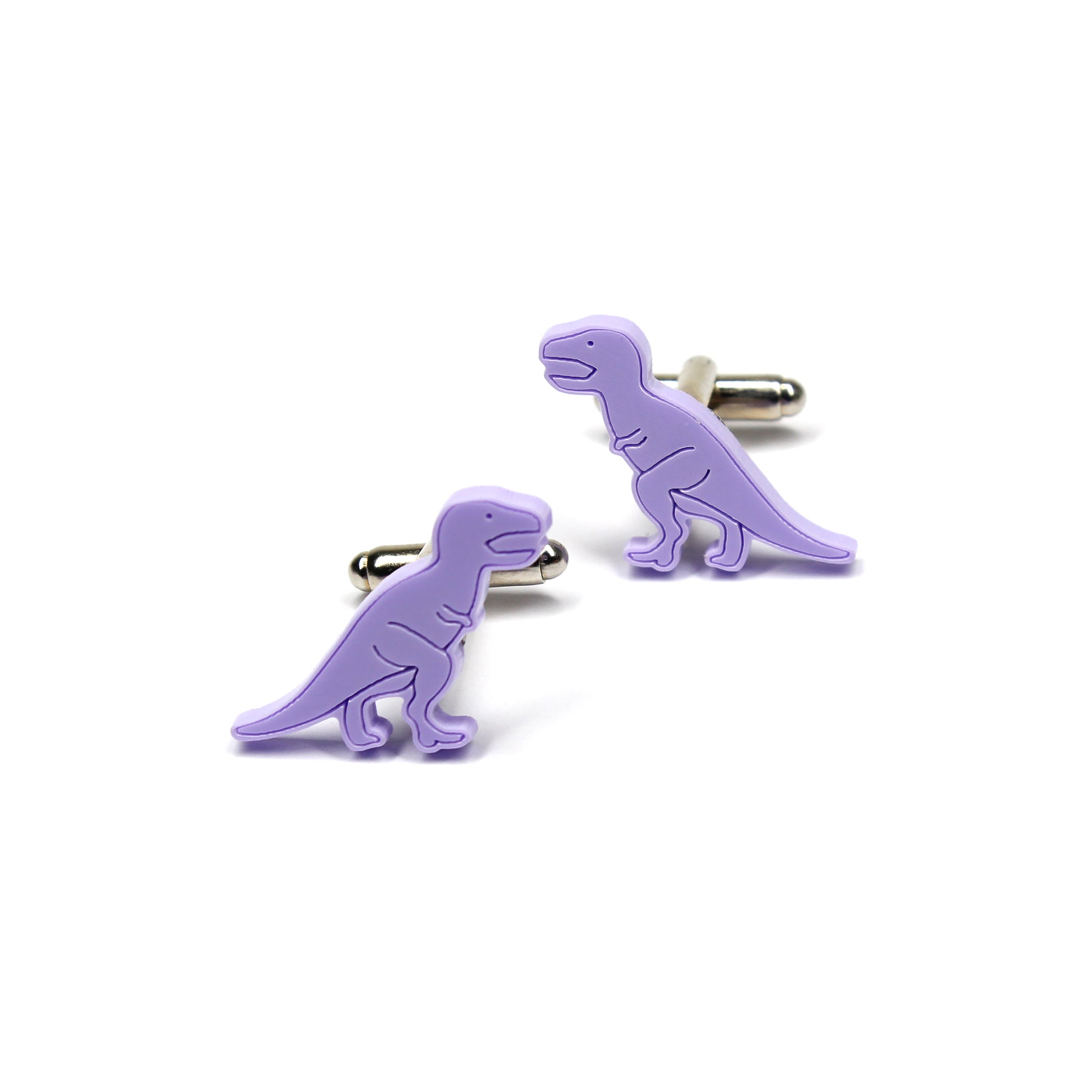 a pair of purple tyrannosaurus-rex dinosaur cufflinks on a white background