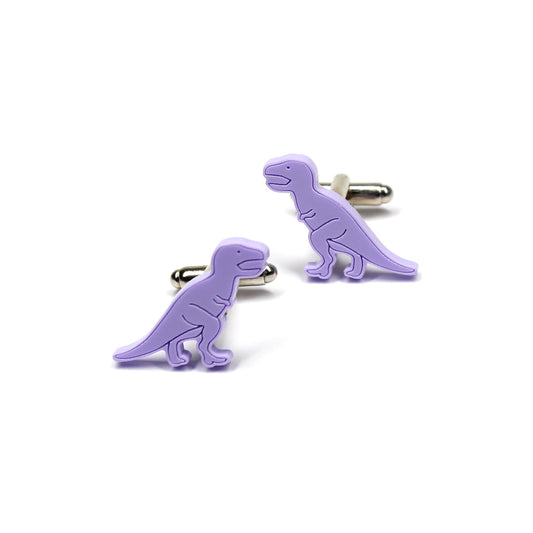 a pair of purple tyrannosaurus-rex dinosaur cufflinks on a white background