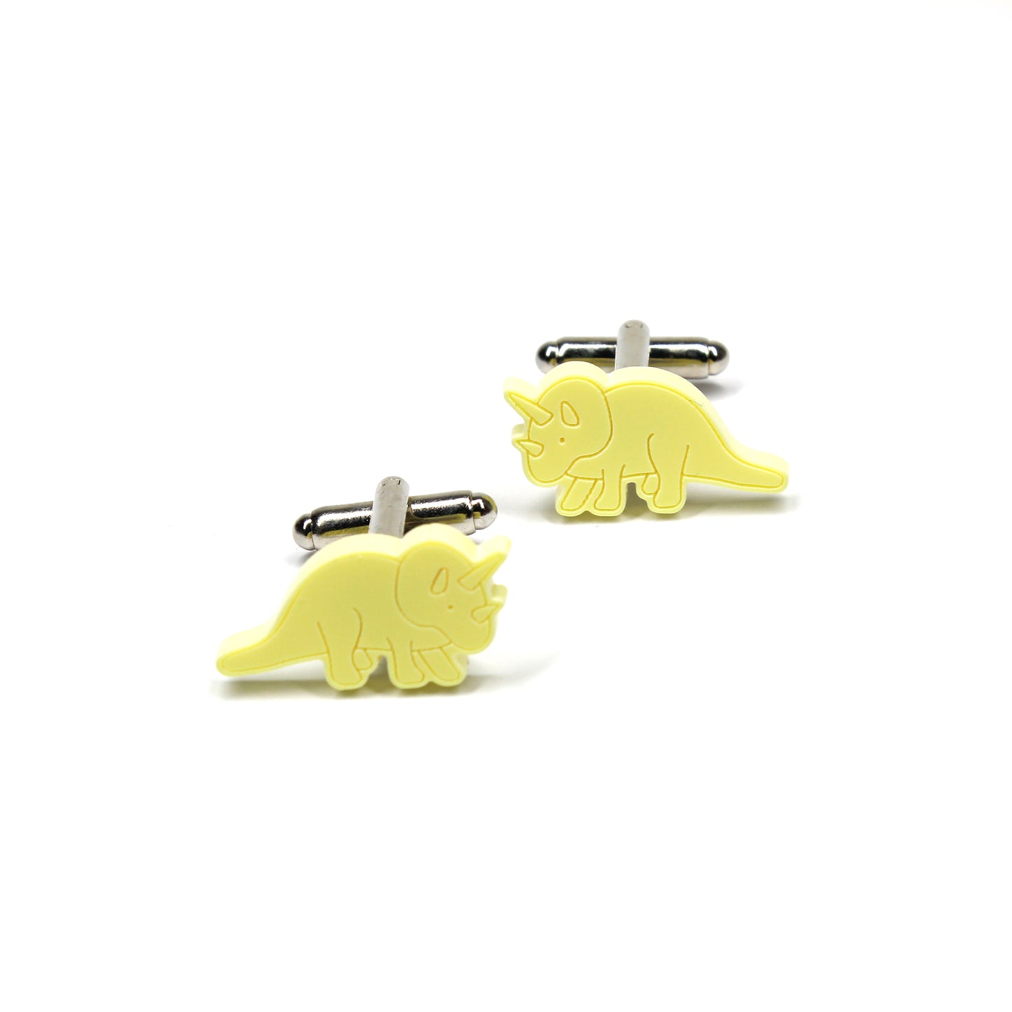a pair of yellow triceratops cufflinks