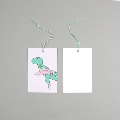 flat lay showing the front and back of the ballet dinosaur gift tag on a grey background