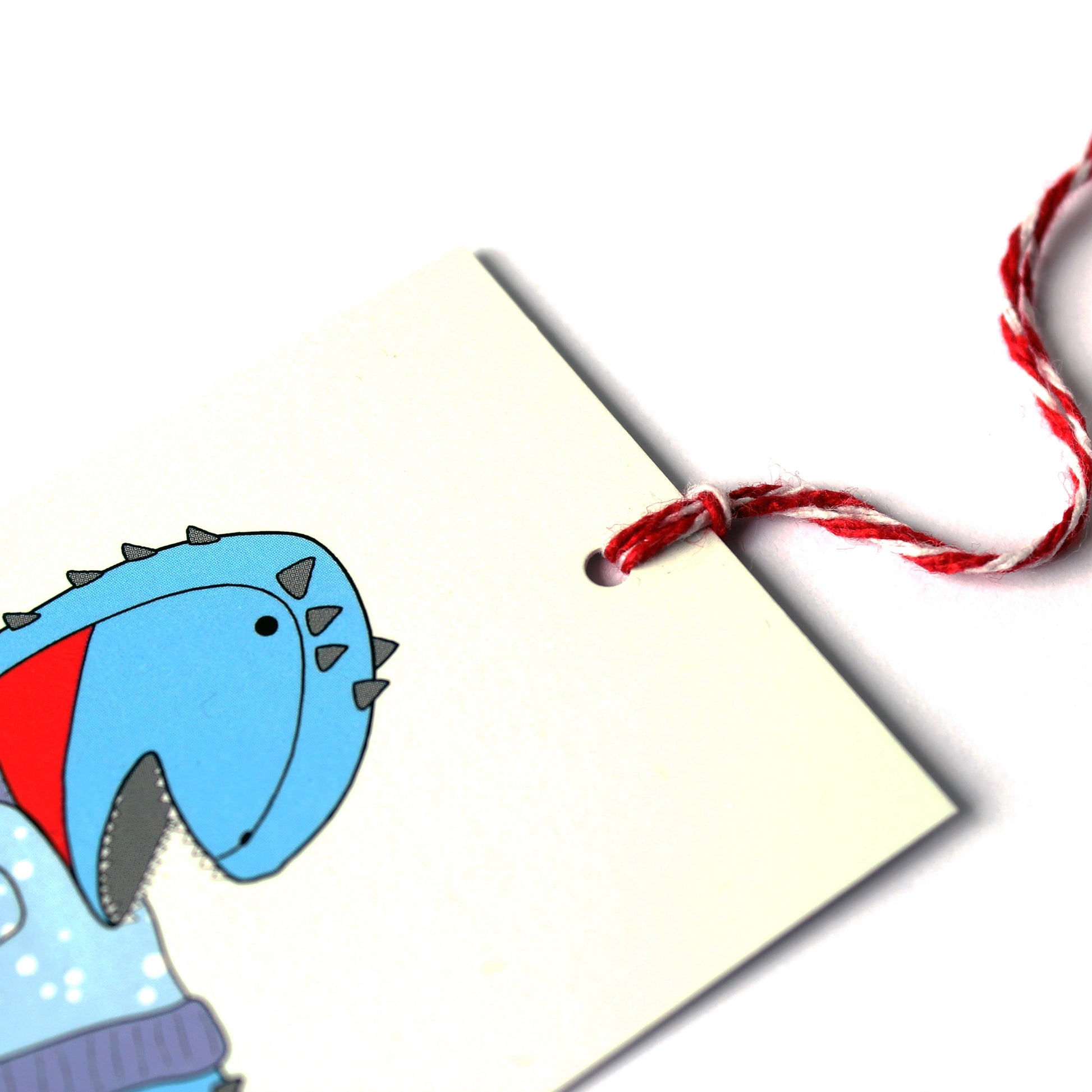 Ugly Christmas jumper dinosaur gift tag close up