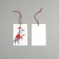 flat lay showing the front and back of the dinosaur Santa Claws gift tag on a grey background