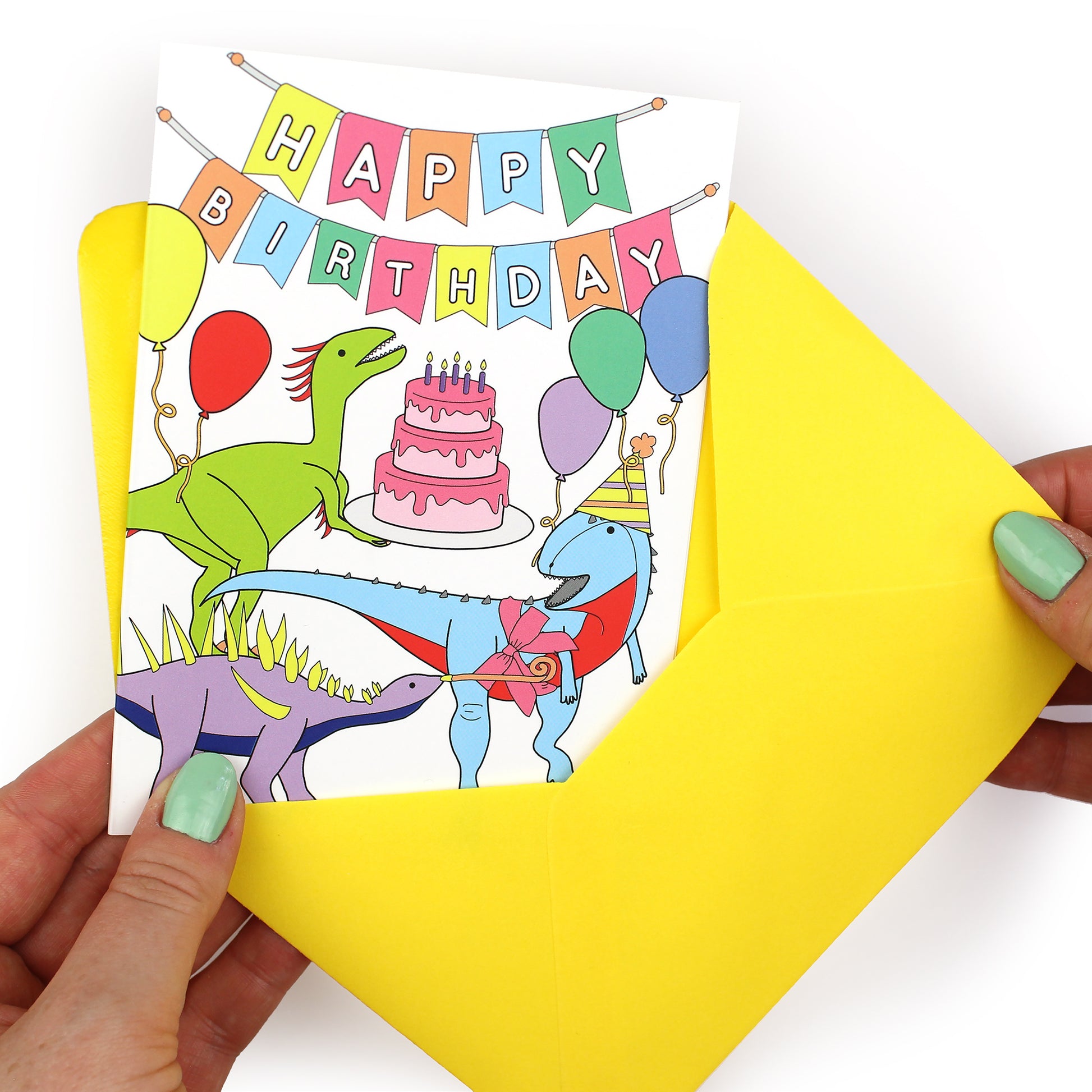 hands holding an envelope while removing the birthday party dinosaur card from the envelope